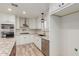 Renovated kitchen with stainless steel appliances, granite countertops, white cabinetry, and wood-look flooring at 7953 W Topeka Dr, Glendale, AZ 85308