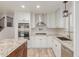Bright kitchen with white cabinets, subway tile backsplash, granite countertops, and stainless steel appliances at 7953 W Topeka Dr, Glendale, AZ 85308