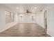 Spacious living room with wood-look tile flooring, bright walls, and plenty of natural light at 7953 W Topeka Dr, Glendale, AZ 85308