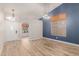 Inviting living room with wood-look tile floors, an elegant chandelier, and lots of natural light at 7953 W Topeka Dr, Glendale, AZ 85308