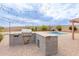 Outdoor kitchen with a built-in grill, counter space, and beautiful pool views, perfect for outdoor gatherings at 7953 W Topeka Dr, Glendale, AZ 85308