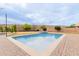 Sparkling swimming pool with a travertine border, surrounded by mature landscaping in a private backyard at 7953 W Topeka Dr, Glendale, AZ 85308