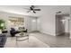 Bright living room with updated flooring, ceiling fan, modern furniture, and natural light at 814 E 11Th Ave, Mesa, AZ 85204