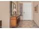 Inviting entryway with tile flooring, a decorative cabinet, a large mirror, and a white front door at 8176 E Sweet Bush Ln, Gold Canyon, AZ 85118