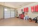 Well-organized garage with a painted floor, storage cabinets, tools, and automatic door at 8176 E Sweet Bush Ln, Gold Canyon, AZ 85118