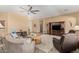 Warm and inviting living room featuring neutral walls, ceiling fan, and a large area rug at 8176 E Sweet Bush Ln, Gold Canyon, AZ 85118