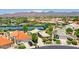 An aerial view of the community featuring mountain views, tennis courts, a neighborhood pool, and desert landscaping at 9444 N 115Th Pl, Scottsdale, AZ 85259