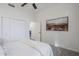 Bright bedroom with carpet features a ceiling fan, closet and an art piece on the wall at 9444 N 115Th Pl, Scottsdale, AZ 85259