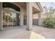 Covered outdoor patio with stone flooring and sliding glass doors to the home's interior at 9444 N 115Th Pl, Scottsdale, AZ 85259