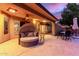 Cozy covered patio with stylish seating and an outdoor ceiling fan at 9725 E Mission Ln, Scottsdale, AZ 85258