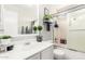 Bathroom featuring a single sink vanity with modern fixtures, decorative shelves, and a shower/tub at 10664 E Emerald Ave, Mesa, AZ 85208