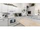 Well-lit kitchen featuring white cabinets, butcher block island, and modern appliances at 10664 E Emerald Ave, Mesa, AZ 85208