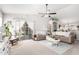 Bright living room with neutral tones, vaulted ceilings, and sliding glass doors to the backyard patio at 10664 E Emerald Ave, Mesa, AZ 85208