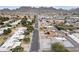 High-angle aerial photograph of homes with a glimpse of local businesses and desert mountains in the distance at 1101 E Cheryl Dr, Phoenix, AZ 85020