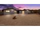 Home with large gravel backyard, secure fencing, and mountain views at dusk at 1101 E Cheryl Dr, Phoenix, AZ 85020