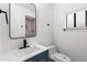 Bright bathroom with a blue vanity, modern fixtures, and a large mirror at 1101 E Cheryl Dr, Phoenix, AZ 85020