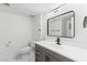 Contemporary bathroom featuring modern vanity, black fixtures, and updated mirror and lighting at 1101 E Cheryl Dr, Phoenix, AZ 85020