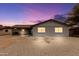 This exterior elevation features a charming brick facade, a driveway, and rock landscaping at 1101 E Cheryl Dr, Phoenix, AZ 85020