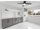 Bright kitchen featuring modern gray cabinets, sleek marble countertops, and a new white refrigerator at 1101 E Cheryl Dr, Phoenix, AZ 85020