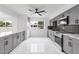 Modern kitchen with gray cabinetry, stylish backsplash, stainless steel appliances, and marble floors at 1101 E Cheryl Dr, Phoenix, AZ 85020