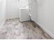 Well-lit laundry area featuring a washer and dryer with modern tile flooring at 1101 E Cheryl Dr, Phoenix, AZ 85020