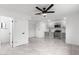 Spacious living room with a ceiling fan, marble floors, and an open layout leading into the kitchen at 1101 E Cheryl Dr, Phoenix, AZ 85020