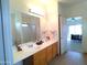 Bathroom featuring a double sink vanity, tiled floors, and a shower with glass doors at 1185 N Sherwood Way, Queen Valley, AZ 85118