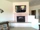 Inviting fireplace with tile surround and mantle with mounted television above at 1185 N Sherwood Way, Queen Valley, AZ 85118