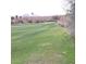 Expansive green of a well-manicured golf course, backed by rugged mountain views at 1185 N Sherwood Way, Queen Valley, AZ 85118