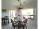 Bright dining room with glass table and seating for four with a large window view at 1185 N Sherwood Way, Queen Valley, AZ 85118