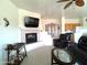 Inviting living room featuring a cozy fireplace, comfortable seating, and plenty of natural light at 1185 N Sherwood Way, Queen Valley, AZ 85118