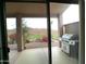 Covered patio with a grill, view of the golf course, and desert landscaping at 1185 N Sherwood Way, Queen Valley, AZ 85118