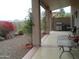 Covered patio featuring a built-in grill, decorative plants, and stunning desert views at 1185 N Sherwood Way, Queen Valley, AZ 85118