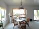 Bright dining room with glass table and seating for four near a bright window at 1185 N Sherwood Way, Queen Valley, AZ 85118