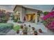 Backyard patio featuring an outdoor seating area, lush landscaping, and beautiful flowers at 11919 E Del Timbre Dr, Scottsdale, AZ 85259