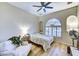 Comfortable bedroom with hardwood floors, a ceiling fan, and a large window at 11919 E Del Timbre Dr, Scottsdale, AZ 85259