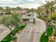 Community entrance featuring a security gate surrounded by palm trees and manicured landscaping at 11919 E Del Timbre Dr, Scottsdale, AZ 85259