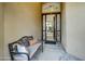 Inviting entryway with a decorative glass door, a comfortable bench, and a view into the living space at 11919 E Del Timbre Dr, Scottsdale, AZ 85259