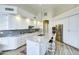 Bright kitchen with granite countertops, white cabinetry, a large island, and stainless steel appliances at 11919 E Del Timbre Dr, Scottsdale, AZ 85259