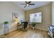 Comfortable home office with hardwood floors, a ceiling fan, and a bright window for natural light at 11919 E Del Timbre Dr, Scottsdale, AZ 85259