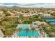 An aerial view of a pool and tennis courts in an upscale housing community in Arizona at 11919 E Del Timbre Dr, Scottsdale, AZ 85259