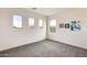 Bedroom with neutral-colored walls, large windows, and carpeted floors at 12246 W Paso Trl, Peoria, AZ 85383