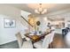 Dining area features modern chandelier, table with seating for six, and tiled floors at 12246 W Paso Trl, Peoria, AZ 85383