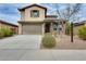 Charming two-story home with desert landscaping, two-car garage and neutral-toned stucco at 12246 W Paso Trl, Peoria, AZ 85383