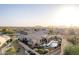 Expansive aerial view of the property showcasing the pool, outdoor entertaining spaces, and desert landscape at 13102 S 177Th Dr, Goodyear, AZ 85338