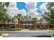 Elegant community clubhouse surrounded by palm trees and a well-maintained lawn at 13102 S 177Th Dr, Goodyear, AZ 85338