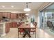 Charming dining area with wood table and chairs, complemented by tile flooring and bright lighting at 13102 S 177Th Dr, Goodyear, AZ 85338