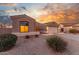 Well-kept single-story home featuring a two-car garage and desert-friendly landscaping under a dramatic sky at 13102 S 177Th Dr, Goodyear, AZ 85338