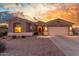 Charming single-story home with a neutral color scheme, complemented by a well-maintained front yard at 13102 S 177Th Dr, Goodyear, AZ 85338