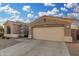 A spacious two-car garage with a wide concrete driveway, part of a well-maintained home at 13102 S 177Th Dr, Goodyear, AZ 85338